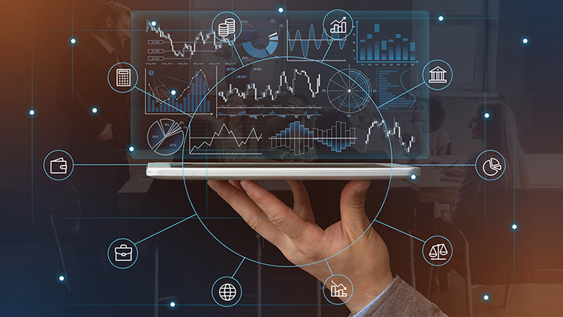 Modern technologies in economics. Hand holds tablet with futuristic virtual hologram graphs and symbols